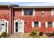 Charming brick condo featuring white trim, bright natural light, and well-maintained landscaping at 2250 S Palmetto Ave # I-11, Daytona Beach, FL 32119