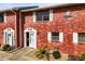 Charming brick condo featuring white trim, bright natural light, and well-maintained landscaping at 2250 S Palmetto Ave # I-11, Daytona Beach, FL 32119