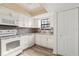 Bright kitchen featuring white appliances, mosaic backsplash, and ample cabinet space with a cozy feel at 2250 S Palmetto Ave # I-11, Daytona Beach, FL 32119