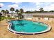 Relaxing community pool with blue tile, palm trees, and poolside seating at 2250 S Palmetto Ave # I-11, Daytona Beach, FL 32119