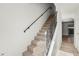 Carpeted staircase with decorative iron railing leads to the upper level of the home at 2250 S Palmetto Ave # I-11, Daytona Beach, FL 32119