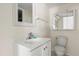 Bathroom featuring a vanity sink, mirror, and toilet at 2250 S Palmetto Ave # I-11, Daytona Beach, FL 32119