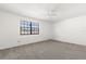 Bright, carpeted bedroom with a ceiling fan and a large window at 2250 S Palmetto Ave # I-11, Daytona Beach, FL 32119