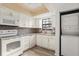 Bright kitchen with white cabinets and appliances and washer and dryer at 2250 S Palmetto Ave # I-11, Daytona Beach, FL 32119