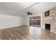Spacious living room with wood flooring, sliding doors, and stone fireplace at 2250 S Palmetto Ave # I-11, Daytona Beach, FL 32119