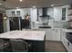 Modern kitchen features a large island, white cabinets, and stainless steel appliances at 2325 Audley St, Oviedo, FL 32765