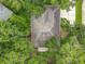 Aerial view of home featuring a unique patterned roof surrounded by lush, mature trees at 2353 Kingscrest Cir, Apopka, FL 32712