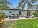 Back patio features outdoor seating and dining area, perfect for entertaining at 2353 Kingscrest Cir, Apopka, FL 32712