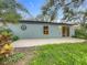 Backyard featuring a well-manicured lawn and mature trees, with a patio area at 2353 Kingscrest Cir, Apopka, FL 32712