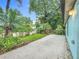 View of backyard with patio, lush tropical landscaping, and privacy fence at 2353 Kingscrest Cir, Apopka, FL 32712