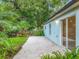 Private backyard with a patio area and tropical foliage at 2353 Kingscrest Cir, Apopka, FL 32712