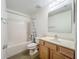 Bathroom with a shower and tub combo, a single vanity, and a large mirror at 2353 Kingscrest Cir, Apopka, FL 32712