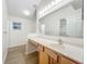 Bathroom featuring a vanity with a large mirror, modern lighting, and a window at 2353 Kingscrest Cir, Apopka, FL 32712