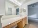 Bright bathroom features a vanity with a makeup table and mirror, and neutral-colored walls at 2353 Kingscrest Cir, Apopka, FL 32712