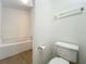 This is a bathroom with a tile-surround tub, wooden floors, and a white toilet at 2353 Kingscrest Cir, Apopka, FL 32712