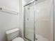 This bathroom has a glass shower, a white toilet, and is well-lit at 2353 Kingscrest Cir, Apopka, FL 32712