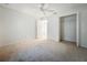Spacious bedroom with neutral carpet, a ceiling fan, walk-in closet and attached bathroom at 2353 Kingscrest Cir, Apopka, FL 32712