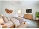 Serene bedroom with wood accents, a mounted TV, and a comfortable, inviting atmosphere at 2353 Kingscrest Cir, Apopka, FL 32712