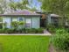 Charming single-story home with a well-manicured lawn and lush landscaping at 2353 Kingscrest Cir, Apopka, FL 32712