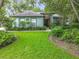 Charming single-story home with a well-manicured lawn and lush landscaping at 2353 Kingscrest Cir, Apopka, FL 32712