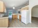 Spacious kitchen with modern appliances, light wood cabinets, and breakfast bar at 2353 Kingscrest Cir, Apopka, FL 32712