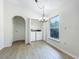 Bright laundry room features a modern washer and dryer, stylish chandelier, and natural light from a large window at 2353 Kingscrest Cir, Apopka, FL 32712