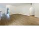 Spacious living room featuring wood-look floors, neutral paint, and arched doorways at 2353 Kingscrest Cir, Apopka, FL 32712