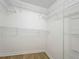 This is a walk-in closet with adjustable metal shelving and white trim at 2353 Kingscrest Cir, Apopka, FL 32712