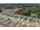 Aerial view of the home showcases its location within a well-maintained neighborhood and lush green surroundings at 253 Fiddlewood Ct, Davenport, FL 33837