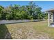 Spacious backyard with lush green grass and a white fence, providing a private and serene outdoor space at 253 Fiddlewood Ct, Davenport, FL 33837