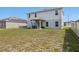 View of the home's backyard featuring the patio, lawn, and home exterior at 253 Fiddlewood Ct, Davenport, FL 33837
