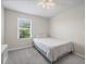 Neutral bedroom with a bed, a ceiling fan, and a window, providing a comfortable and inviting space at 253 Fiddlewood Ct, Davenport, FL 33837