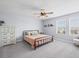 Cozy bedroom with a metal bed frame, light gray walls, and a ceiling fan at 253 Fiddlewood Ct, Davenport, FL 33837