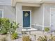 Close-up of the front door with decorative wreath and well-manicured landscaping at 253 Fiddlewood Ct, Davenport, FL 33837
