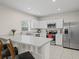 Bright kitchen showcases white cabinetry, stainless steel appliances, and granite countertops at 253 Fiddlewood Ct, Davenport, FL 33837