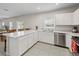 An open kitchen showcases white cabinets, stainless steel appliances, and a long island with seating at 253 Fiddlewood Ct, Davenport, FL 33837