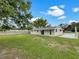 Expansive backyard with lush greenery, offering plenty of space for recreation and gardening projects at 2575 King Ave, Auburndale, FL 33823