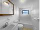 This well-lit bathroom offers a vanity with a sink, toilet, and a bathtub with tiled walls at 2575 King Ave, Auburndale, FL 33823