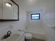 This well-lit bathroom offers a vanity with a sink, toilet, and a bathtub with tiled walls at 2575 King Ave, Auburndale, FL 33823