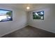 This bedroom features neutral walls, carpet and two windows at 2575 King Ave, Auburndale, FL 33823
