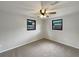 Bedroom with a ceiling fan and two windows providing natural light at 2575 King Ave, Auburndale, FL 33823