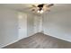 This bedroom features neutral walls and carpet and a lighted ceiling fan at 2575 King Ave, Auburndale, FL 33823