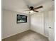 Bedroom features neutral carpet, a ceiling fan, and a black-trimmed window offering natural light at 2575 King Ave, Auburndale, FL 33823