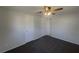 This bedroom features neutral walls and carpet and a lighted ceiling fan at 2575 King Ave, Auburndale, FL 33823