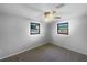 Bright bedroom with plush neutral carpet, twin windows and ceiling fan with lighting at 2575 King Ave, Auburndale, FL 33823