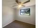 This bedroom features neutral walls and carpet and a lighted ceiling fan at 2575 King Ave, Auburndale, FL 33823