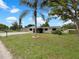 Charming single-story home featuring a screened porch, freshly painted exterior, and landscaped front yard at 2575 King Ave, Auburndale, FL 33823