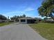 Charming single-story home featuring a screened porch, freshly painted exterior, and landscaped front yard at 2575 King Ave, Auburndale, FL 33823