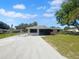 Charming single-story home featuring a screened porch, freshly painted exterior, and landscaped front yard at 2575 King Ave, Auburndale, FL 33823
