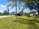 Charming single-story home featuring a screened porch, freshly painted exterior, and landscaped front yard at 2575 King Ave, Auburndale, FL 33823